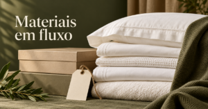 Composição de tecidos dobrados, etiqueta em branco e caixas organizadas que sugere controle de materiais hoteleiros.